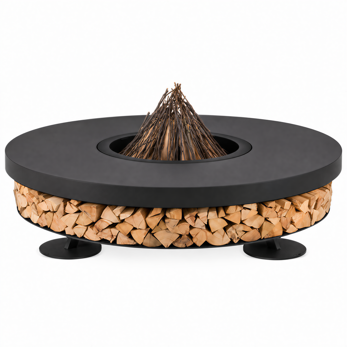 A round outdoor fire pit table with a matte black metal top and legs, a natural wood fire starter cone, and a base filled with stacked firewood logs, shown on a white background.