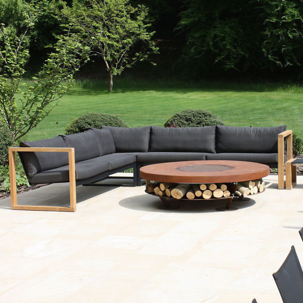 A modern outdoor fire pit table designed to combine warmth, functionality and contemporary style. Featuring a wide circular tabletop with a built-in central fire pit, the base also provides convenient integrated storage for firewood.

Its low-profile round design creates a natural gathering point for outdoor entertaining, while the durable metal construction and clean architectural form suit a wide range of landscape and patio settings. Ideal for gardens. 
